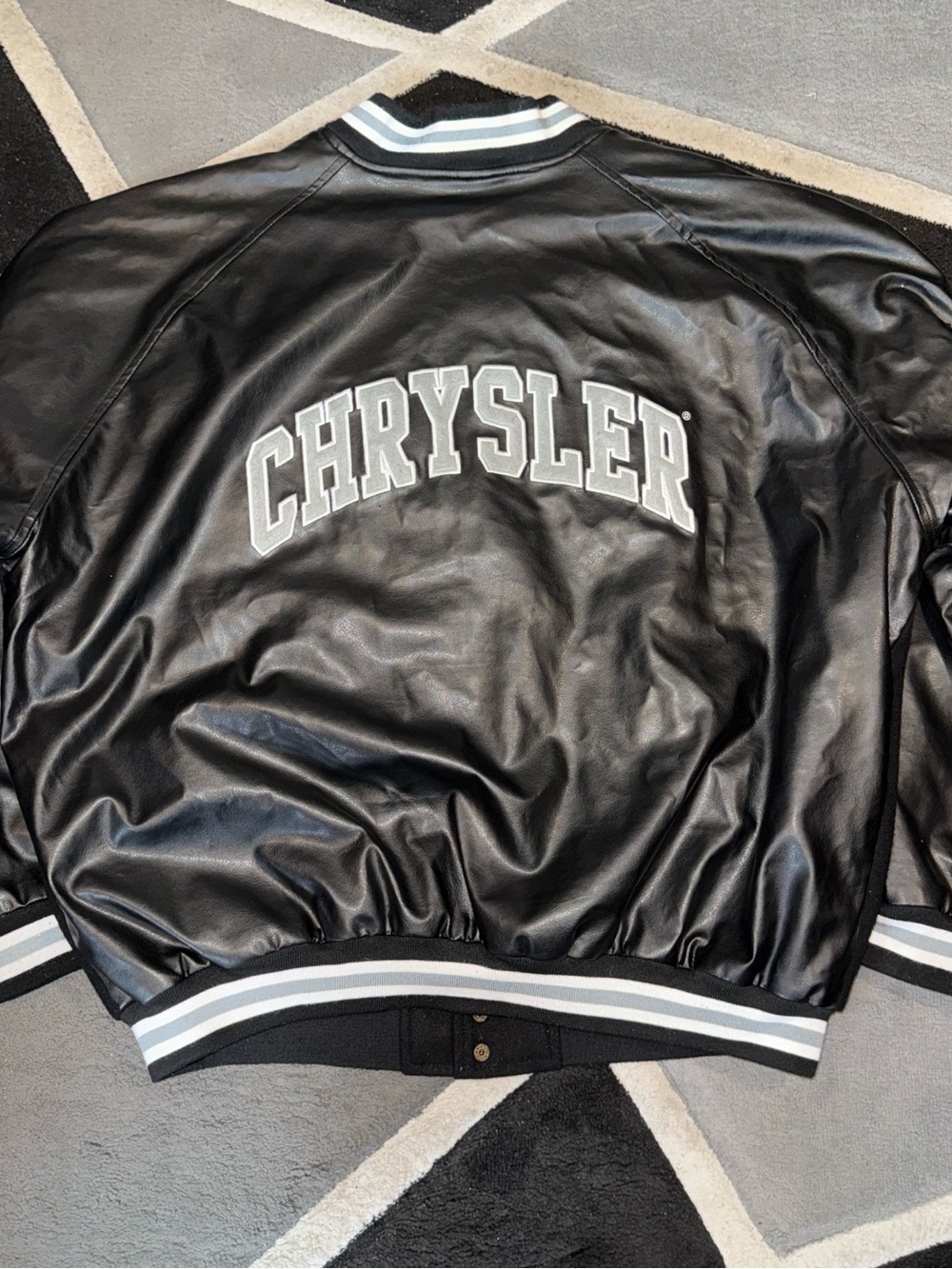 Black Chrysler pleather bomber jacket with white accents